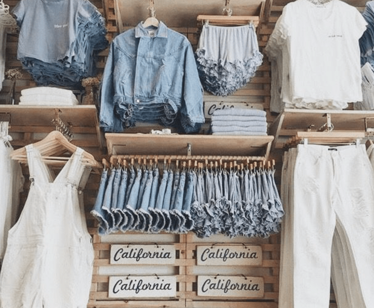 A group of people standing in front of a store

Description automatically generated